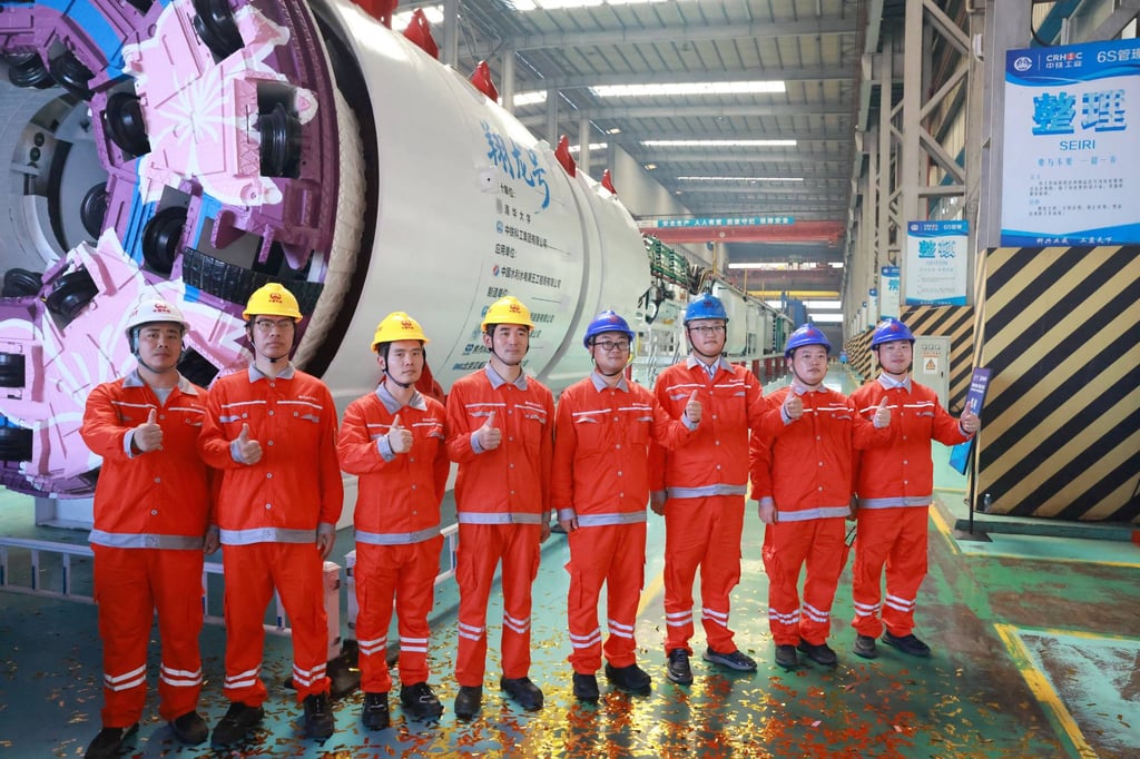 Representatives of the workers who contributed to the manufacturing of the boring and blasting machine pose for a group photo in Wuhan last Saturday. Photo: Xinhua Representatives of the workers who contributed to the manufacturing of the boring and blasting machine pose for a group photo in Wuhan last Saturday. Photo: Xinhua
