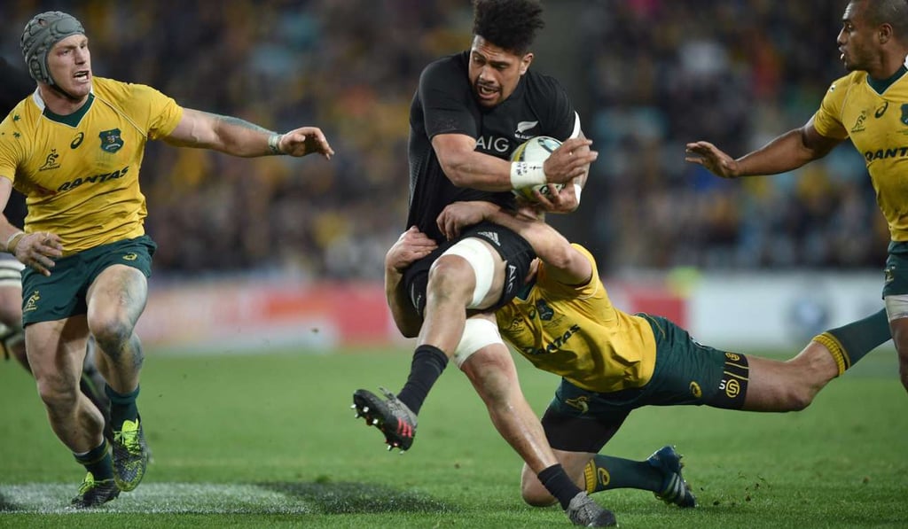 Ardie Savea of New Zealand is tackled by Dane Haylett-Petty of Australia in Sydney. Photo: AFP