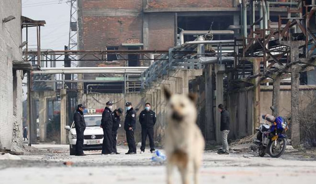 Police officers stand at the site of the explosion in Tongling. Photo: Reuters