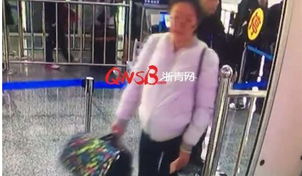 The student pictured in surveillance footage at the station with the cat hidden under her clothing. Photo: Handout The student pictured in surveillance footage at the station with the cat hidden under her clothing. Photo: Handout