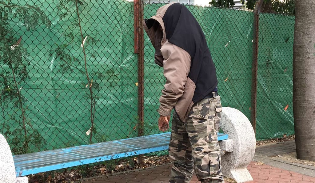 The accused left the court building with his parka draped over his head. Photo: Jasmine Siu