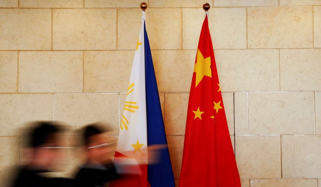The Chinese and Philippine flags are seen outside a room in Beijing where a bilateral meeting was being held. The Chinese and Philippine coastguard can indeed cooperate as President Duterte wishes. Photo: Reuters