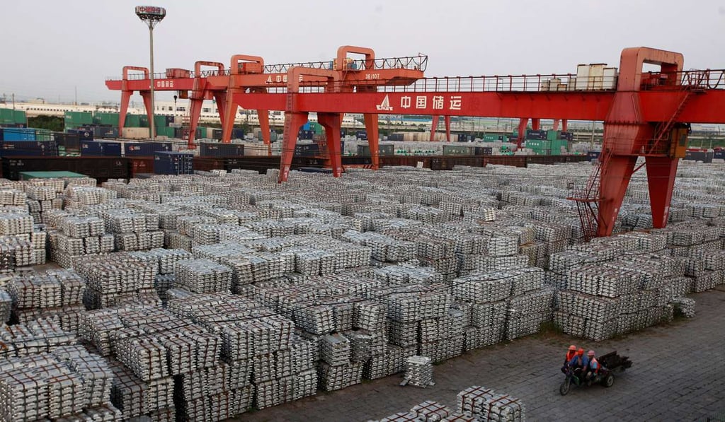 Workers ride on an motor rickshaw through an aluminium ingots depot in Wuxi, Jiangsu province, China. Photo: Reuters