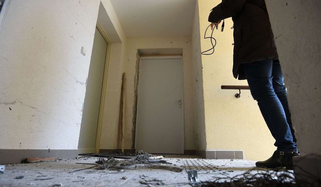 A journalist films the debris of an explosion after French anti-terrorist police raided an apartment in Clapiers, near Montpellier. Photo: AFP A journalist films the debris of an explosion after French anti-terrorist police raided an apartment in Clapiers, near Montpellier. Photo: AFP