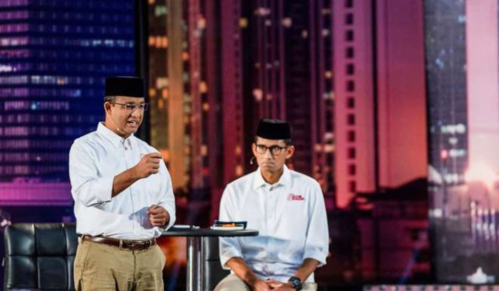 Anies Basweden, left, and his deputy Sandiaga Uno during a televised debate in Jakarta. Photo: Reuters