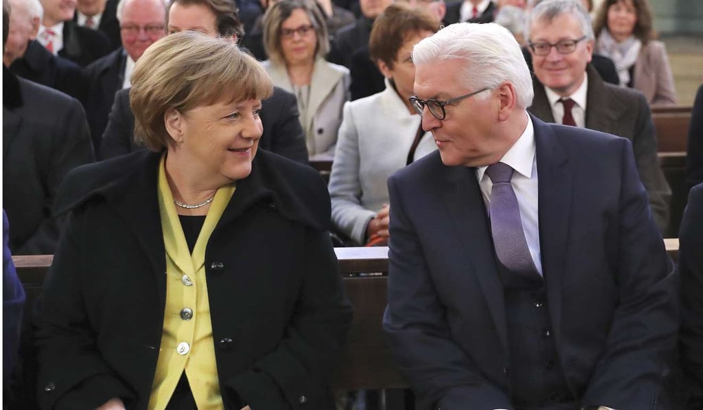 Former German foreign minister and presidential candidate, Frank-Walter Steinmeier, right, and German chancellor Angela Merkel. Photo: AP