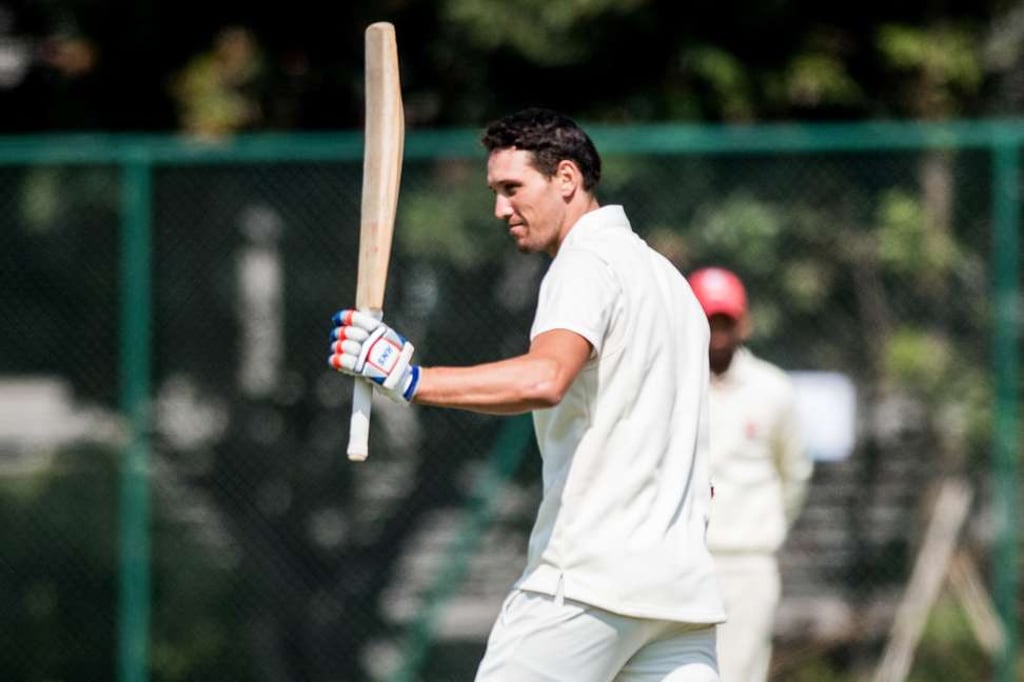 Ben Cooper raises his bat after scoring a century. Photo: Panda Man Ben Cooper raises his bat after scoring a century. Photo: Panda Man