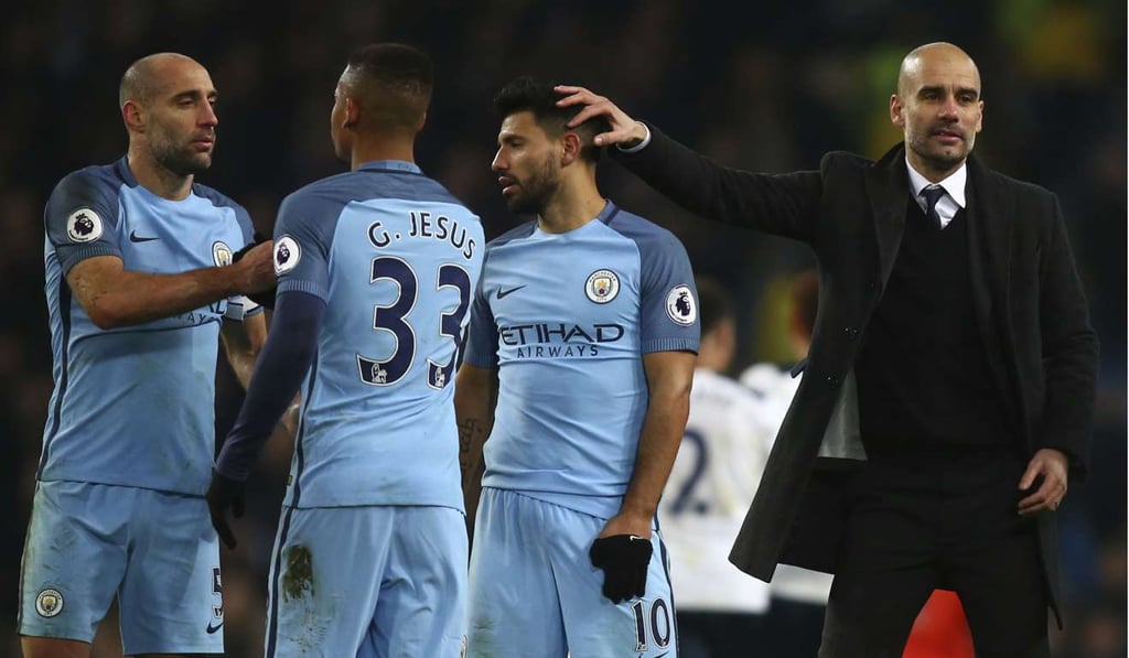 Manchester City manager Pep Guardiola (right) rubs the head of Sergio Aguero. Photo: AP