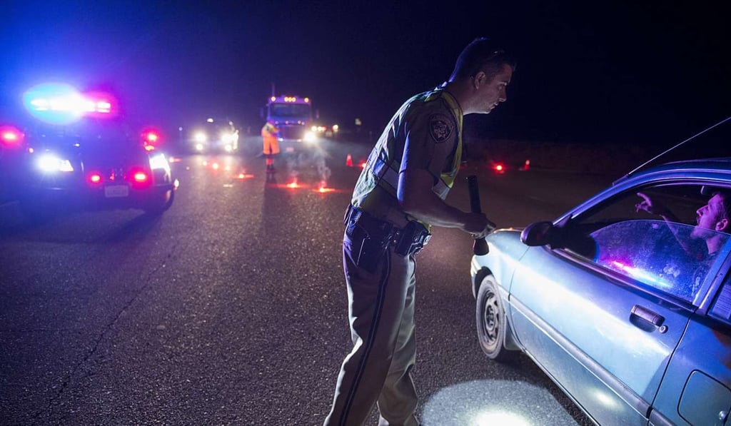 California Highway Patrol officer Ken Weckman directs traffic as residents evacuate Marysville, California, on Sunday as an emergency spillway of the Oroville Dam threatened to collapse. Photo: AP California Highway Patrol officer Ken Weckman directs traffic as residents evacuate Marysville, California, on Sunday as an emergency spillway of the Oroville Dam threatened to collapse. Photo: AP