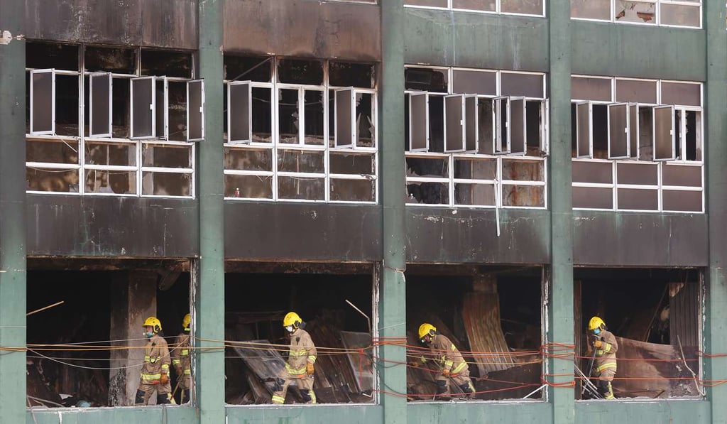 Firemen survey the damage at the site of the fire in Ngau Tau Kok last June. Photo: Sam Tsang