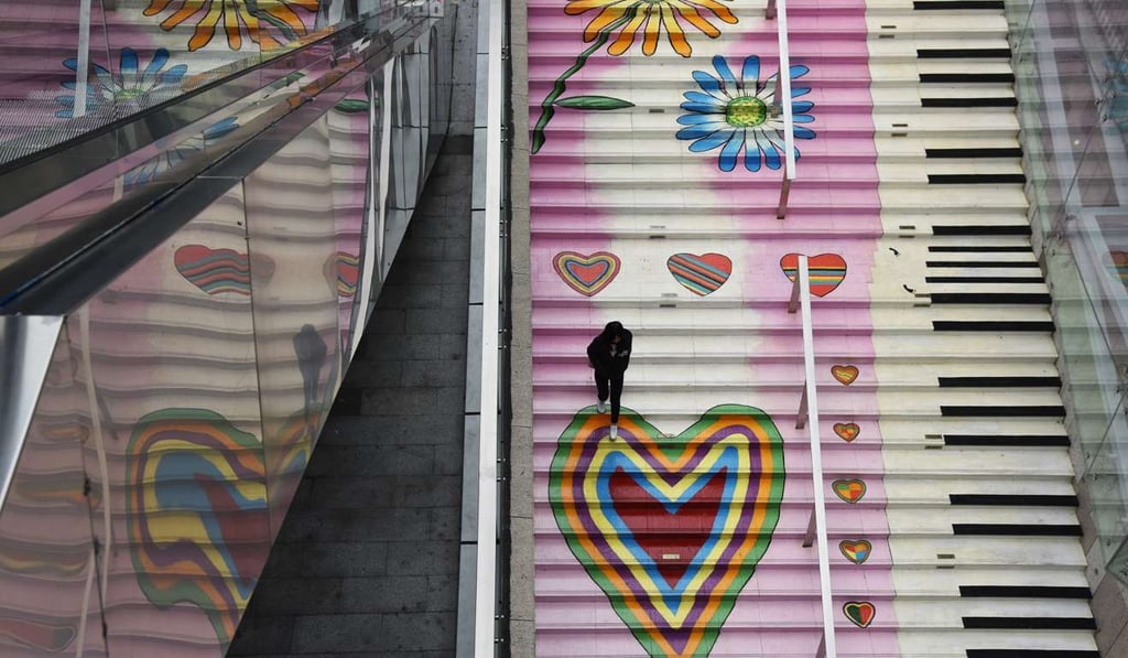 A man walks on the steps of the staircase painted with Valentine's Day decorations in Shenzhen. Photo: Imginechina