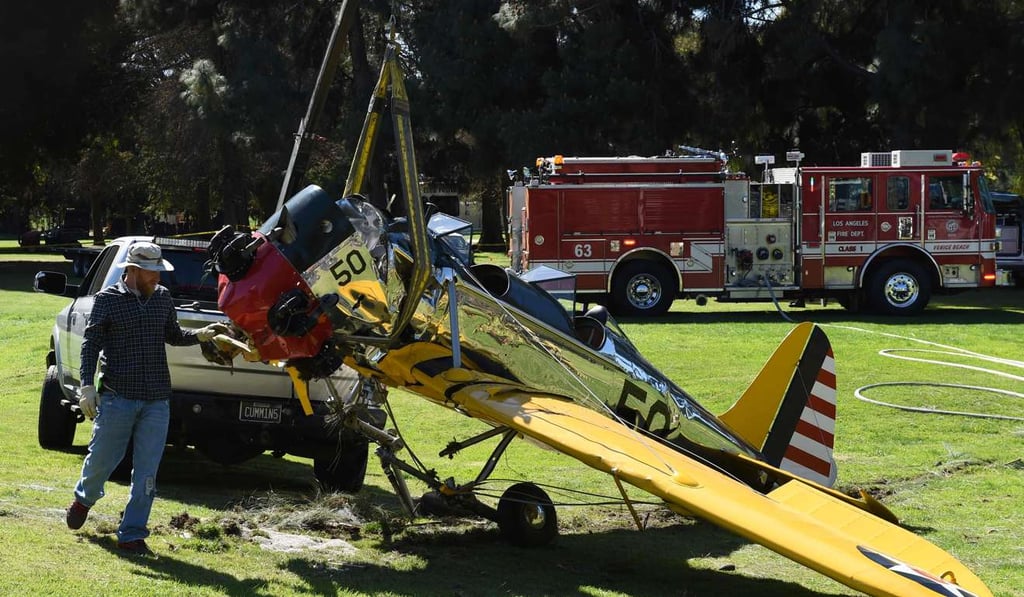 Firefighters and an aviation official remove the 1942 Ryan Aeronautical plane that crashed onto a California golf course on March 6, 2015, and was piloted by US actor Harrison Ford. Photo: AFP Firefighters and an aviation official remove the 1942 Ryan Aeronautical plane that crashed onto a California golf course on March 6, 2015, and was piloted by US actor Harrison Ford. Photo: AFP