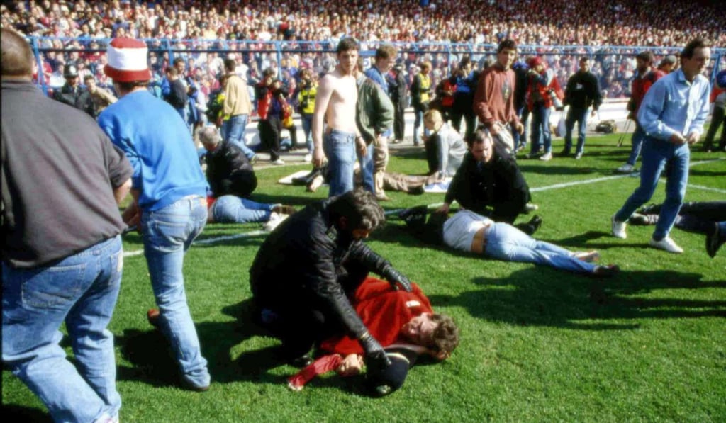 In this April 15, 1989, file photo, police, stewards and supporters tend to victims of the spectator crush at Hillsborough Stadium, in Sheffield, in which 96 Liverpool fans were killed. Photo: AP