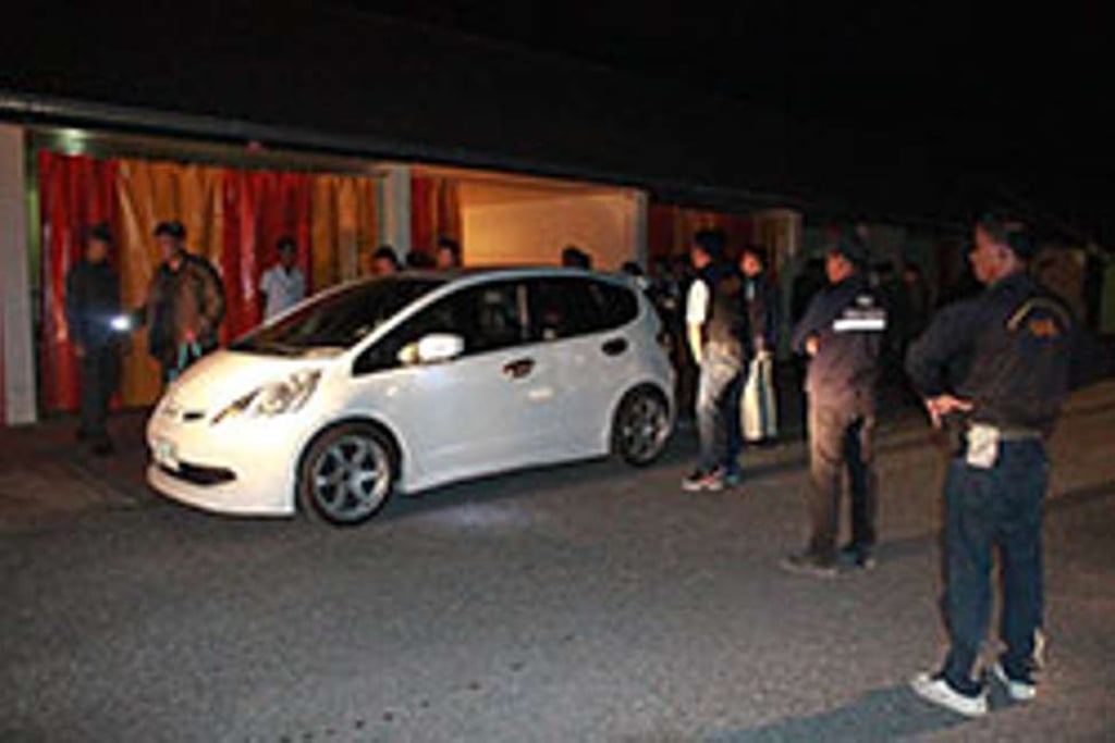 Officials raid a room at a love motel after a saffron robe and monk's bag were found left inside a car parked in front of the room on Tuesday night. Photo: Chinnawat Singha/Bangkok Post