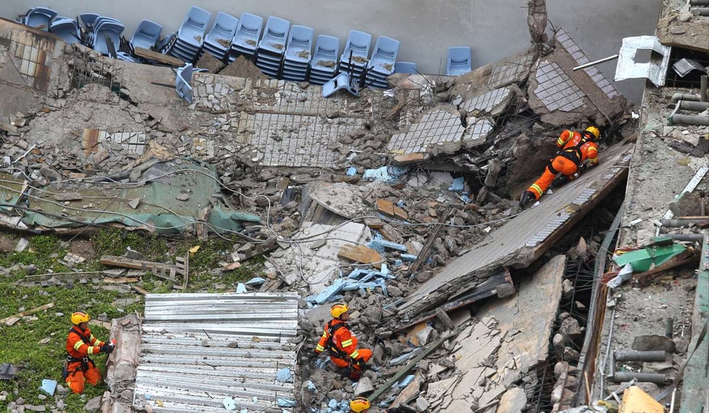 Firemen pick through the rubble. Photo: Dickson Lee