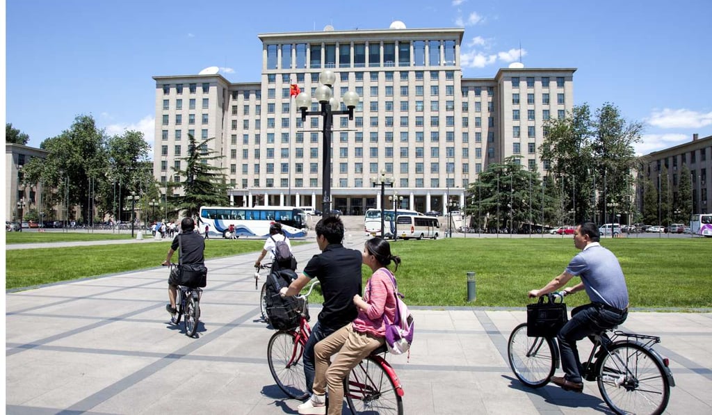 Students cycle past the main building on campus at Tsinghua University in Beijing. Photo: Handout