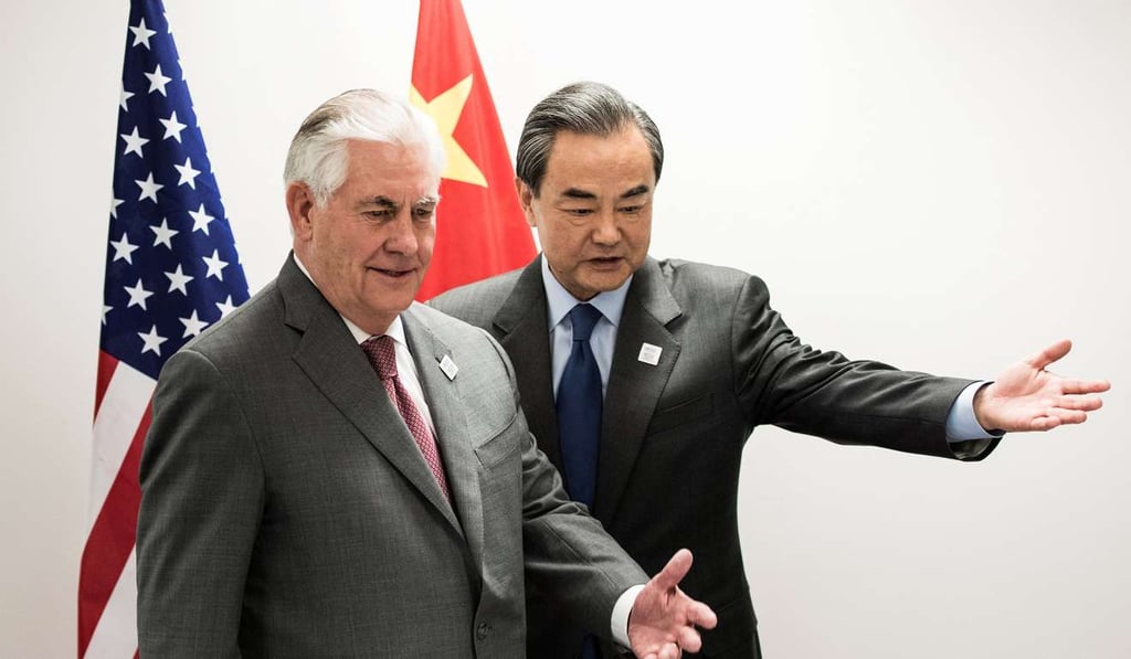 Tillerson and Wang take their seats before their meeting. Photo: Reuters