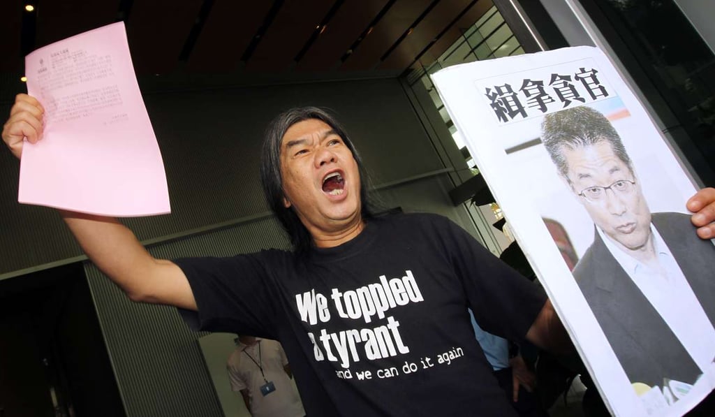 Lawmaker Leung Kwok-hung demands that development chief Paul Chan step down as he files a complaint with the ICAC in North Point, on July 23, 2013. Chan denied a conflict of interest concerning the government’s proposed development of the Northeast New Territories after a newspaper report said Chan’s wife, Freida Hui, and her family owned farmland in Kwu Tung North, earmarked as a new town. Chan had failed to declare this when taking office. Photo: Dickson Lee