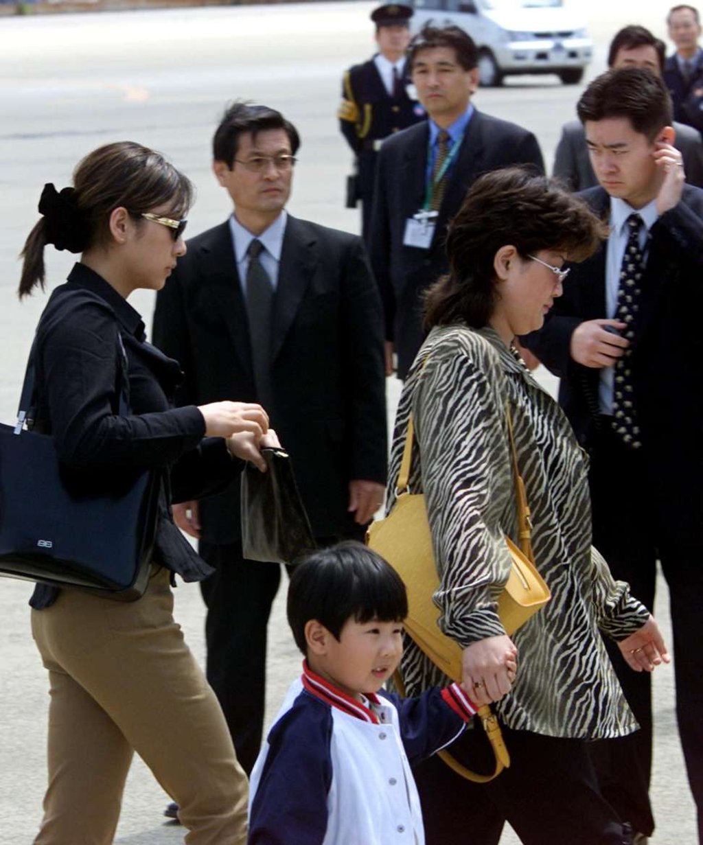 Two women and a boy, who had been detained with a man, believed to be Kim Jong-nam, son of North Korean leader Kim Jong-il, board a plane at Narita airport near Tokyo, May 4, 2001. Picture: AFP