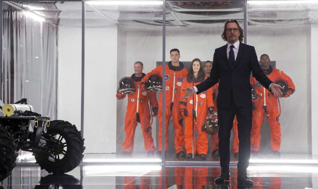 Gary Oldman (wearing a suit) in a still from The Space Between Us.