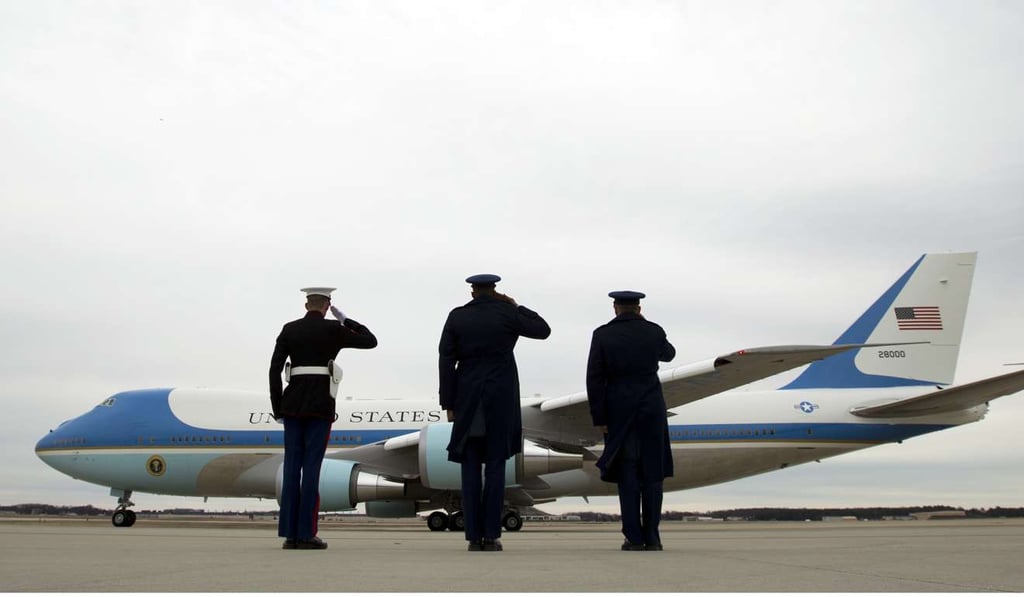 Military personnel salute as Air Force One departs from Andrews Air Force Base in Maryland on February 10. Photo: AP