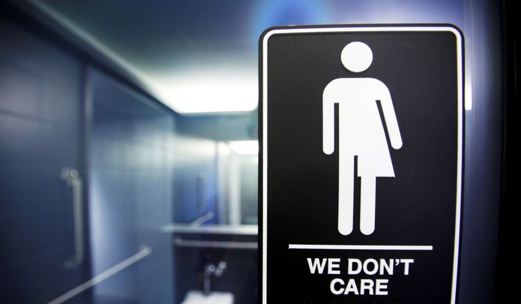 A sign protesting a North Carolina law restricting transgender bathroom access adorns the bathroom stalls at the 21C Museum Hotel in Durham, North Carolina. Photo: Reuters
