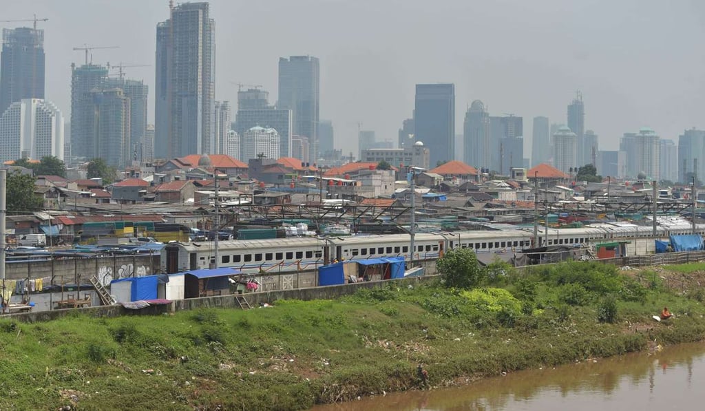 High-rise buildings behind residential houses in Central Jakarta. Photo: AFP