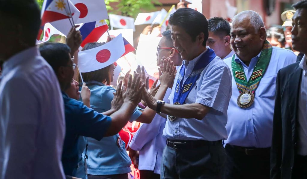 Japan’s Prime Minister Shinzo Abe greets teachers at the Mindanao Kokusai Daigaku in Davao City, the Philippines. Photo: AFP Japan’s Prime Minister Shinzo Abe greets teachers at the Mindanao Kokusai Daigaku in Davao City, the Philippines. Photo: AFP