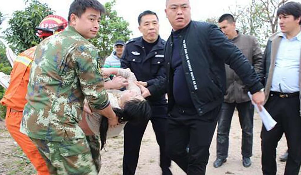 The woman is carried ashore. She was conscious throughout was taken to hospital for observation. Photo: Handout