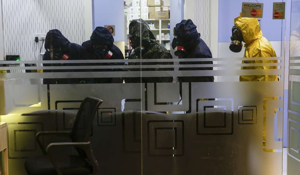 A Hazmat (hazardous materials) team conducts checks at the clinic where Kim Jong-nam was initially examined. Photo: EPA A Hazmat (hazardous materials) team conducts checks at the clinic where Kim Jong-nam was initially examined. Photo: EPA