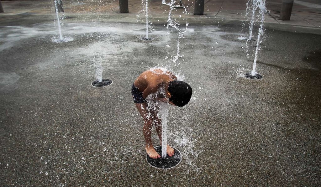 A boy plays in a water feature at the Marina Barrage, a reservoir in the heart of Singapore’s business district. Photo: AP