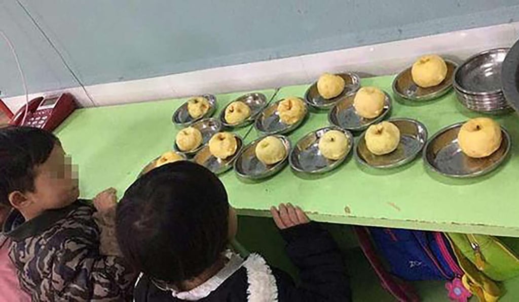 Kindergarten pupils inspect some of substandard apples allegedly provided to them as snacks. Photo: Handout