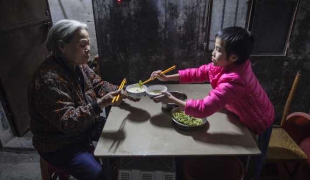 Xiuxia shares dinner with Huang Mengyi, now in her 70s, a neighbour who has cared for the girl all her life. Photo: Handout