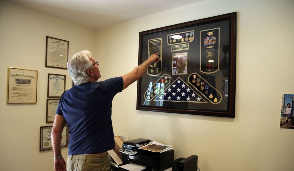 William Owens talks about his son, Navy SEAL William Ryan Owens, who was killed in Yemen on January 29. He keeps a large display of his son's medals and honours in his office in Lauderdale by the Sea, Florida. Photo: TNS