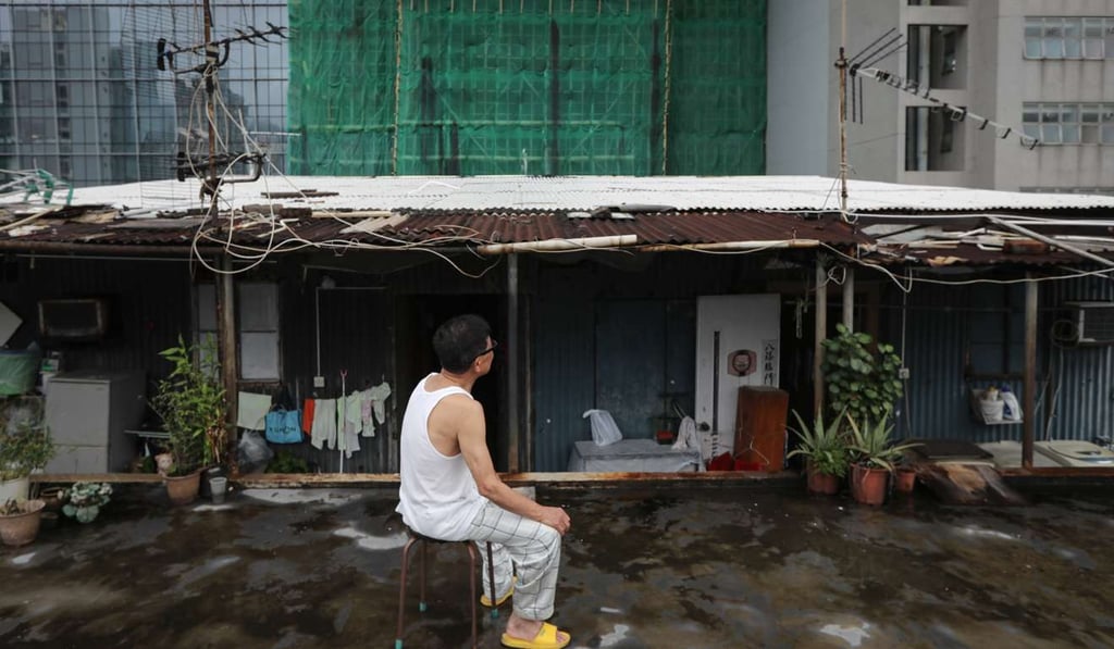 A man sits outside his subdivided unit at a factory block in Kwun Tong last year. Affordable housing is in short supply in Hong Kong. Photo: Bruce Yan