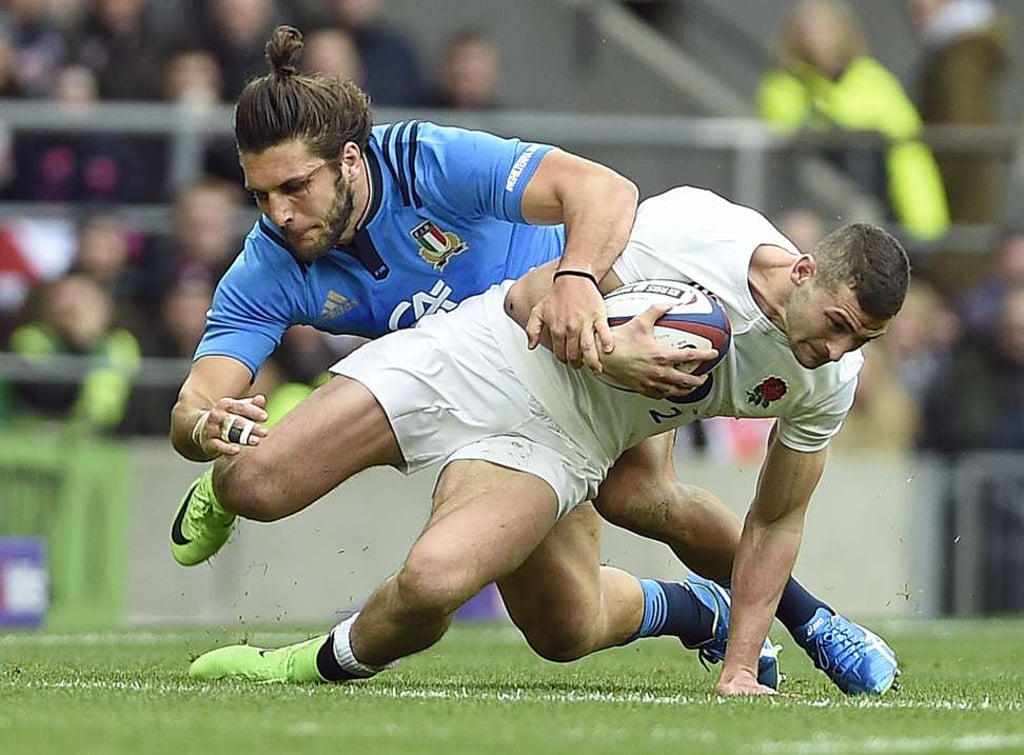 England’s Jonny May is tackled by Italy’s Luke McLean. Photo: EPA England’s Jonny May is tackled by Italy’s Luke McLean. Photo: EPA