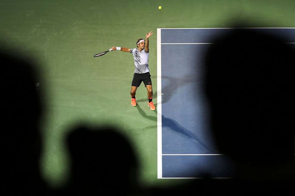 Federer serves the ball to France’s Paire. Photo: AFP