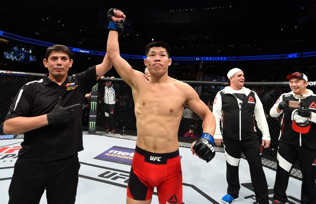 Li Jingliang of China celebrates his knockout victory over Bobby Nash in their welterweight bout during UFC Fight Night. Photo: Getty