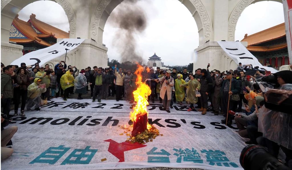 Taiwanese burn a Kuomintang flag in front of the Chiang Kai-shek Memorial Hall in Taipei on Tuesday. Remembrance of the 1947 uprising crushed by the KMT government has become a rallying call for Taiwan’s pro-independence forces and helped to propel the rise of the pro-independence Democratic Progressive Party. Photo: EPA Taiwanese burn a Kuomintang flag in front of the Chiang Kai-shek Memorial Hall in Taipei on Tuesday. Remembrance of the 1947 uprising crushed by the KMT government has become a rallying call for Taiwan’s pro-independence forces and helped to propel the rise of the pro-independence Democratic Progressive Party. Photo: EPA