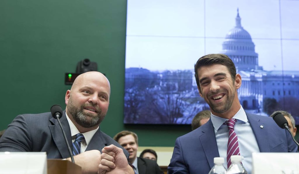 US shot putter and Olympic gold medalist Adam Nelson (L) and retired US swimmer and Olympic gold medalist Michael Phelps (R) fist-bump one another while appearing before the House Energy and Commerce subcommittee hearing, 'Ways to Improve and Strengthen the International Anti-Doping System'. Photo: EPA US shot putter and Olympic gold medalist Adam Nelson (L) and retired US swimmer and Olympic gold medalist Michael Phelps (R) fist-bump one another while appearing before the House Energy and Commerce subcommittee hearing, 'Ways to Improve and Strengthen the International Anti-Doping System'. Photo: EPA