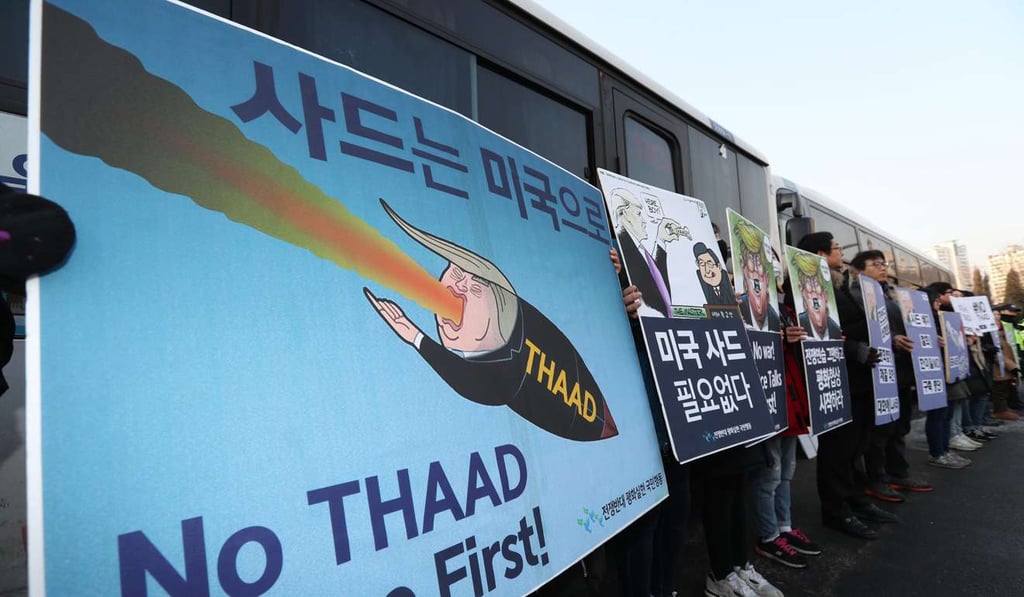South Korean demonstrators hold placards opposing the deployment of the anti-missile system. Photo: EPA