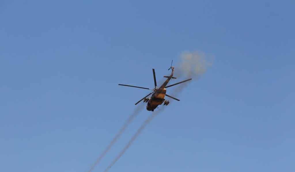A helicopter fires towards the Taliban during a fight between Taliban and Afghan security forces in Laghman province, Afghanistan. Photo: Reuters