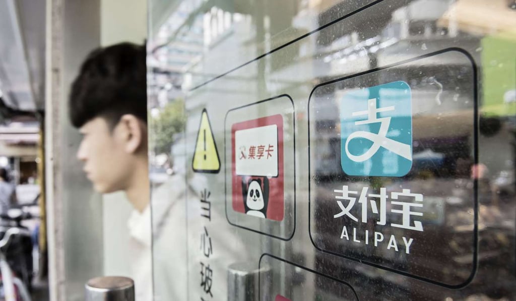 Signage for Ant Financial Services Group's Alipay payment system is displayed on a store entrance in Shanghai on August 31, 2016. Photo: Bloomberg