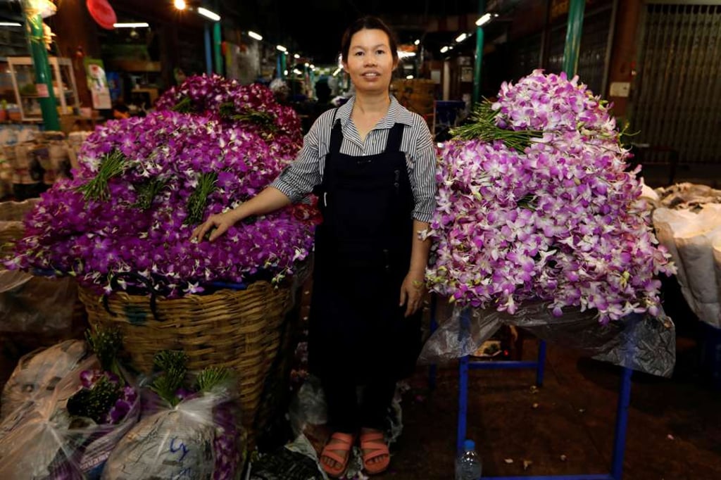 Ram, 46, poses for a photograph at her stall at the flower market in Bangkok, Thailand, as part of a series of photos on working women, ahead of International Women’s Day on March 8. Photo: Reuters