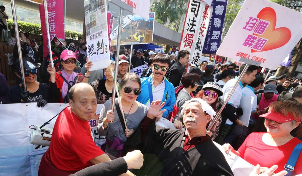 Supporters of the seven jailed officers march to police headquarters in a protest against the sentences. Photo: Felix Wong