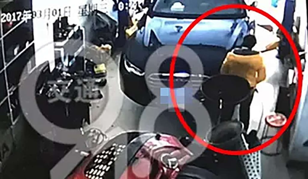 The woman, filmed on the garage security camera, is seen walking away. Photo: Handout