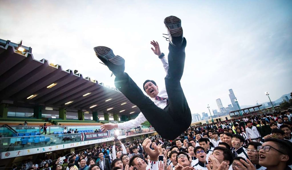 Celebrating students give Ronnie Cheng a lift. Photo: Handout Celebrating students give Ronnie Cheng a lift. Photo: Handout