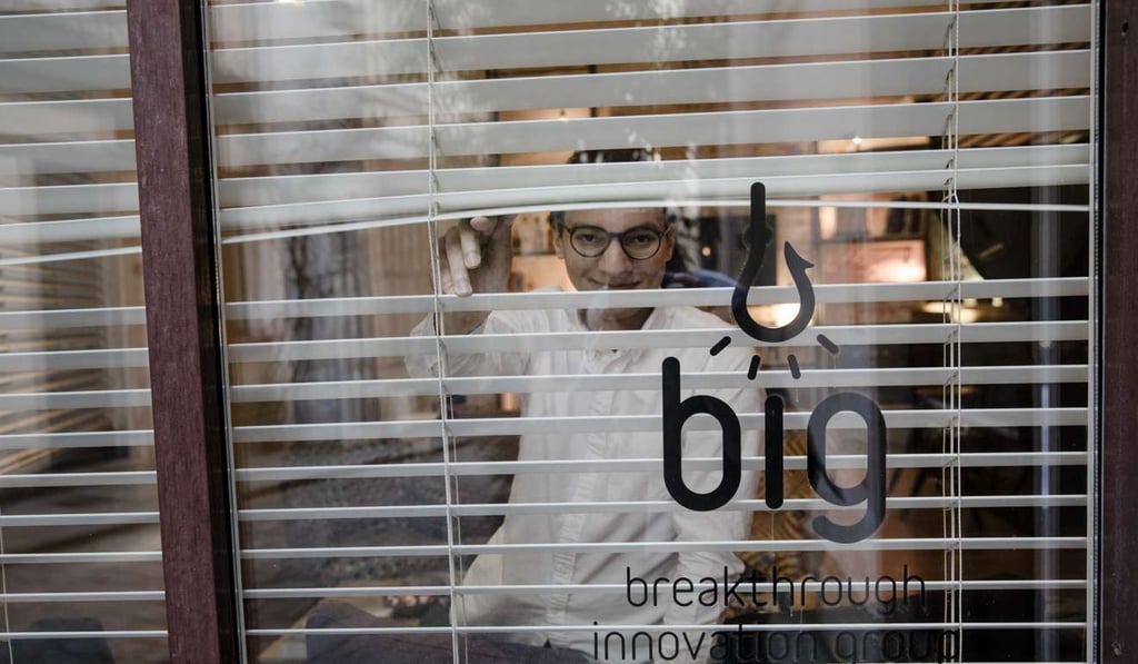 Erwan Castain, innovation manager at Pernod Ricard SA's Breakthrough Innovation Group (BIG), peers through venetian blind inside the BIG office in Paris. Photo: Bloomberg