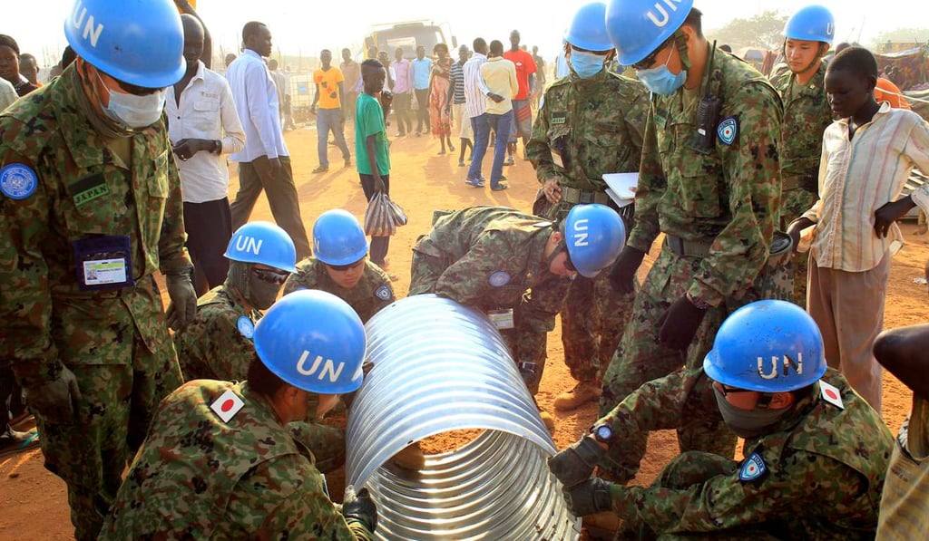 United Nations Mission in South Sudan (UNMISS) peacekeepers from Japan assemble a drainage pipe at Tomping camp, where some thousands of people who fled their homes following fighting were being sheltered by the United Nations, in Juba in 2014. Photo: Reuters