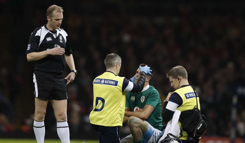 English referee Wayne Barnes (L) looks on as Ireland's scrum-half Conor Murray receives medical attention during the Six Nations international rugby union match between Wales and Ireland at the Principality Stadium in Cardiff, south Wales, on March 10, 2017. / AFP PHOTO / Adrian DENNIS / RESTRICTED TO EDITORIAL USE. Use in books subject to Welsh Rugby Union (WRU) approval. English referee Wayne Barnes (L) looks on as Ireland's scrum-half Conor Murray receives medical attention during the Six Nations international rugby union match between Wales and Ireland at the Principality Stadium in Cardiff, south Wales, on March 10, 2017. / AFP PHOTO / Adrian DENNIS / RESTRICTED TO EDITORIAL USE. Use in books subject to Welsh Rugby Union (WRU) approval.
